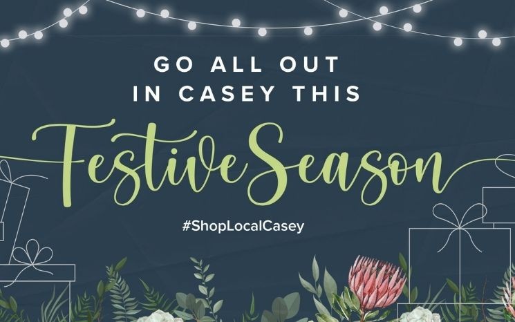 Illustration with text 'Go All Out in Casey this Festive Season', Christmas motifs